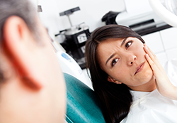 woman with tooth pain needs tooth extraction in Fairfield, CA